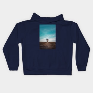 walking a desolate field Kids Hoodie